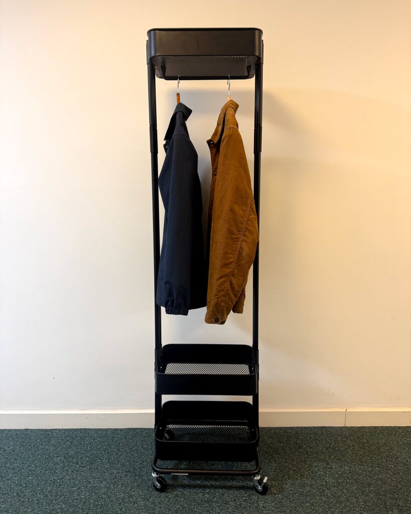 Completed modified RÅSKOG trolley used as a clothes rack in its intended space.