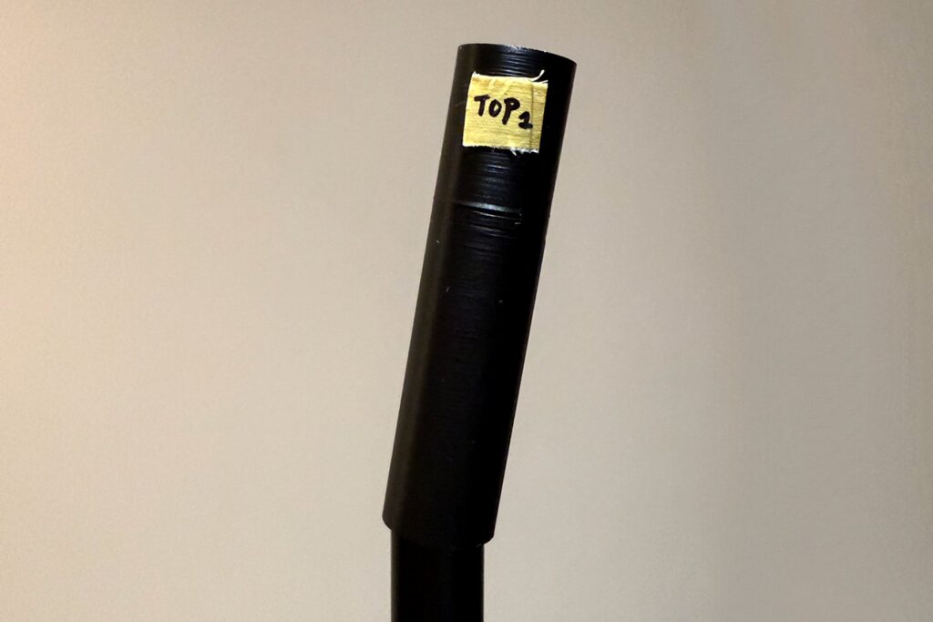 Upper connector fitted to one aluminium tube during an early fit test.